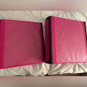 Two pink binders with tab dividers